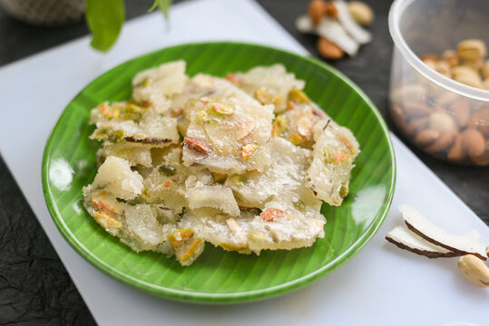Petha Indian sweet sugar barfi or Burfi Diwali sweets Mithai , translucent soft dry fruits pista almond candy made from ash gourd , Delhi India. Kalakand