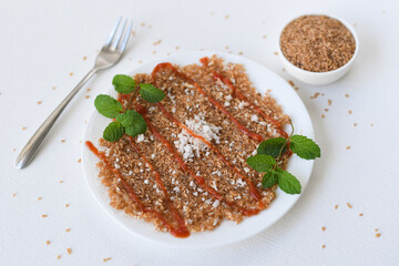 Broken wheat dosa or Roti with tomato sauce , Kerala breakfast , tea time snack with broken wheat and grated coconut. Sweet food 