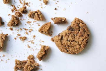 Chocolate chip cookies with crumbs isolated on white background