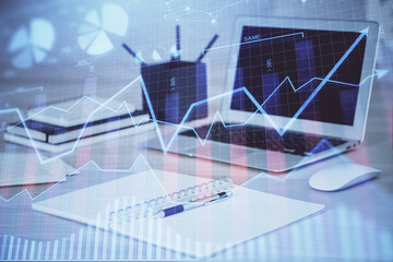 Stock market graph and table with computer background. Multi exposure. Concept of financial analysis.