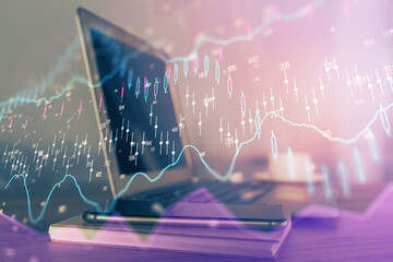 Financial chart drawing and table with computer on background. Multi exposure. Concept of international markets.