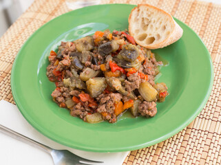 dish of vegetable stew. stewed eggplant, minced meat, carrots, peppers, onion squid