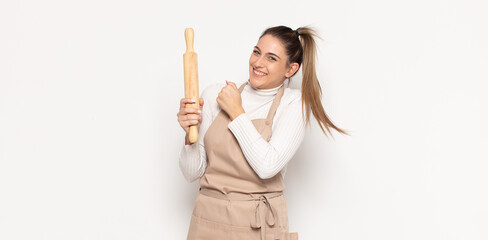 young blonde woman feeling happy, positive and successful, motivated when facing a challenge or celebrating good results