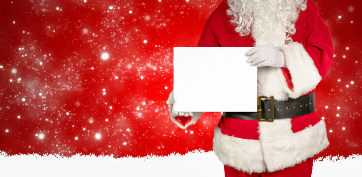 santa holds an empty white panel for advertising in the camera