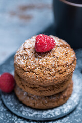 Oatmeal cookies closeup with raspberry on stone plate