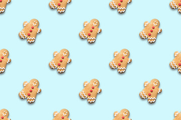 Seamless pattern of Christmas gingerbread man on blue background. Xmas background.