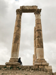 Fototapeta na wymiar Boy contemplating the Roman ruins of the Amman citadel