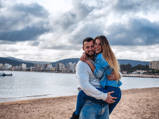 Fototapeta na wymiar Couple walking on the beach of the mediterranean sea