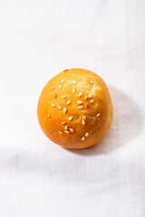 One homemade burger buns with sesame seeds