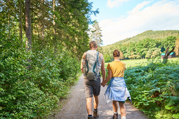 Young couple hiking in Elbsandstein Mountains in East Germany