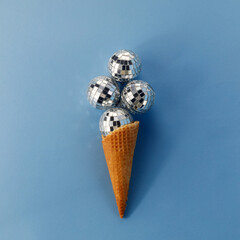 Disco balls ice cream on blue background. Flat lay.