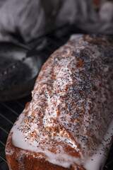 Freshly baked poppy seed pie. Cake with fondant. Baking with poppy seeds on a dark background