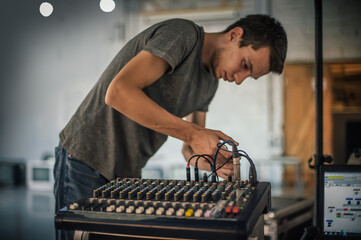 Behind the scene. Sound technician electric engineer adjusting sound elements backstage. Control...