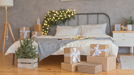 Christmas gifts by the holiday decorated bed