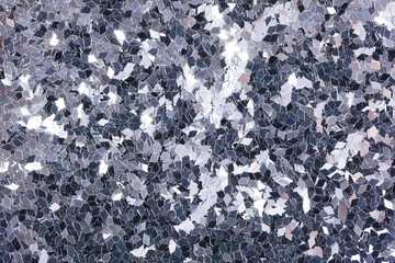 Christmas holographic glitter background with shiny surface, texture in grey tone.