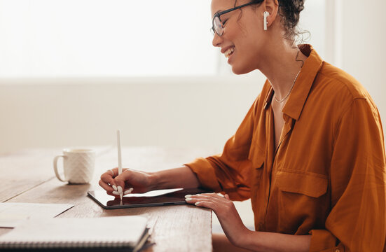 Woman Using Digital Tablet Working From Home