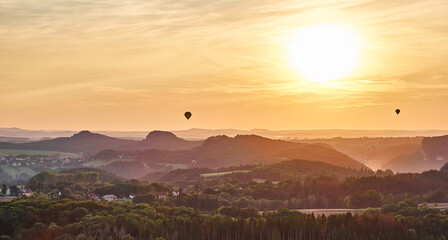 Hot air balloons at sunset in Saxon Switzerland in East Germany