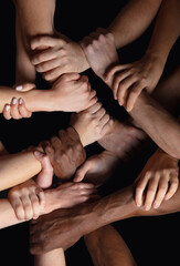 Together, peace. Hands of people's crows in touch isolated on black studio background. Concept of...