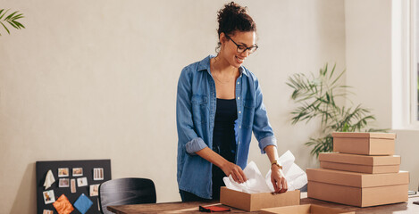 Woman preparing product for deliver to customer