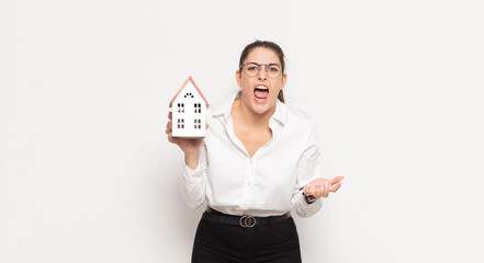 young blonde woman looking angry, annoyed and frustrated screaming wtf or what’s wrong with you