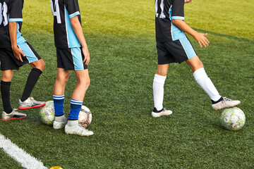 kids boys training with ball before sport competition, they are preparing for match in stadium, 8-9 years old children in unifrom