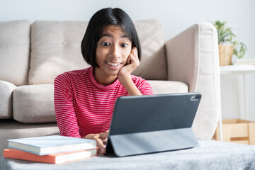 Asian girl expression excited on face while sitting watching  tablet 