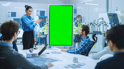 On a Meeting Female Chief Industrial Engineer Reports to a Group of Specialists, Managers, Uses Digital Whiteboard with Green Screen Chroma Key Display. Finding Solution in Modern Factory Office