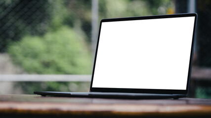 Blank screen white color laptop with blurry background, object put on desk table.