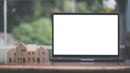 Blank screen white color laptop with blurry background, object put on desk table, mock up.