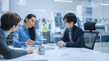 Diverse Team of Computer Engineers and Specialists Gather Around Conference Table, They Discuss Project Drafts, Find Problem Solutions. Electronic Factory. Office Meeting Room.