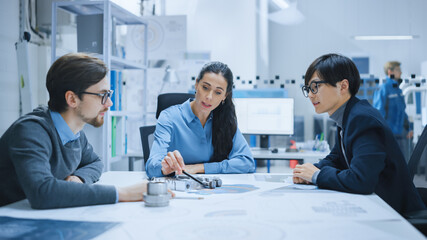 Diverse Team of Computer Engineers and Specialists Gather Around Conference Table, They Discuss...