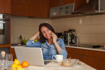 Woman hearing good news on smart phone at home