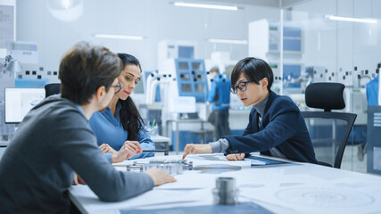 Diverse Team of Computer Engineers and Specialists Gather Around Conference Table, They Discuss Project Drafts, Find Problem Solutions. Electronic Factory. Office Meeting Room.