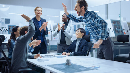 Multi Ethnic Team of Industrial Engineers Standing at the Conference Table Successfully Solve...