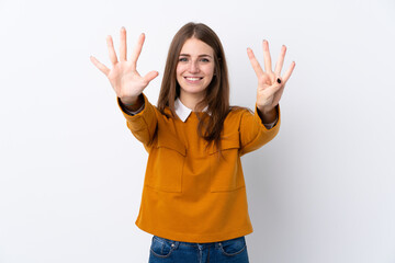 Young woman over isolated white background counting nine with fingers