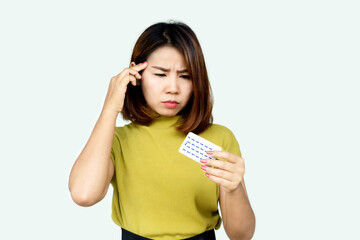 Asian woman forget and confuse to take contraceptive pill with wonder face 