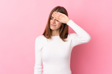 Young woman over isolated pink background with tired and sick expression