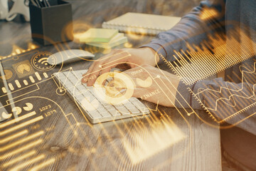 Technology theme hologram with man working on computer on background. High tech concept. Multi exposure.