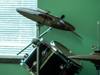 Black drum kit close-up. Musician set with mix of drums in studio. Musical instruments devices for...