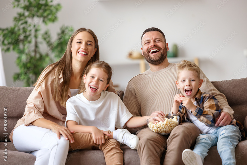 Wall mural Happy family watching comedy together.