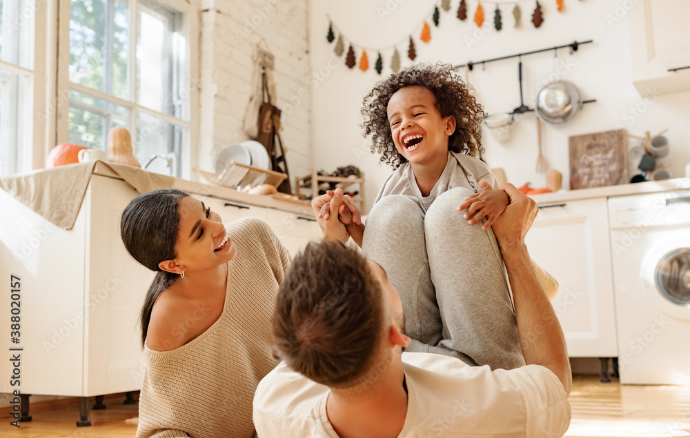 Canvas Prints happy multiracial family playing in kitchen.