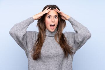 Teenager Brazilian girl over isolated blue background with surprise expression