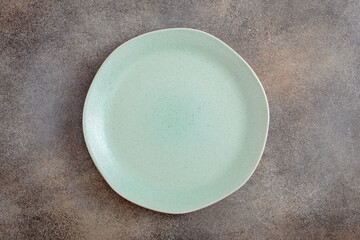 Empty green irregular plate on concrete background. Top view, with copy space - 388021398