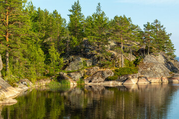 Fototapeta na wymiar beautiful landscape with natural green plants and trees, rocks, mountain and pond, river in Karelia, Russia