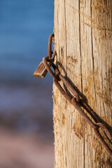 old padlock on a wood by the beach