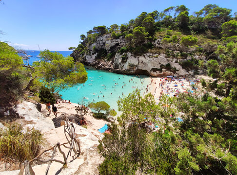 Cala Macarelleta famous paradise beach with turquoise water and pine forests on south coast of Menorca Island, Balearic Islands, Spain.