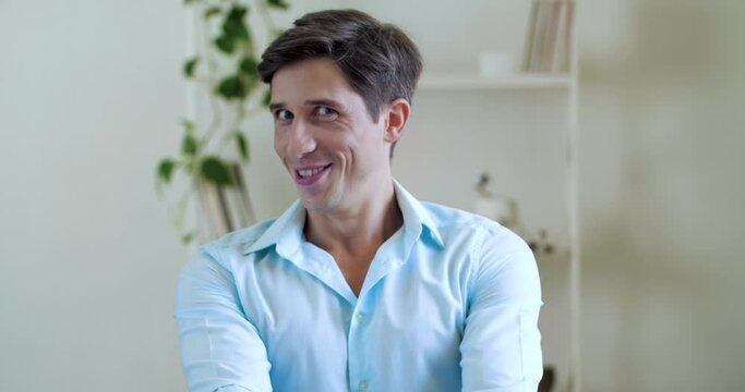 Close up Attractive funny man amazed surprised, pleasantly shocked emotions male face, laughs with joke, points finger to camera, looks flirty with love, puts his hand to his lips, sends air kiss