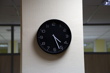 black wall clock on a column
