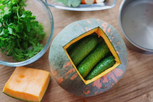 Fresh cucumbers in pumpkin with spices, ready for pickling. Cook at home. lifestyle. shallow depth of field