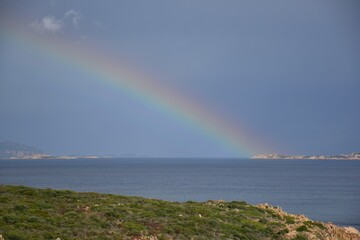 Rainbow over the sea at Sardinian coast, Italy